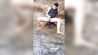 Man masturbation in outdoor river